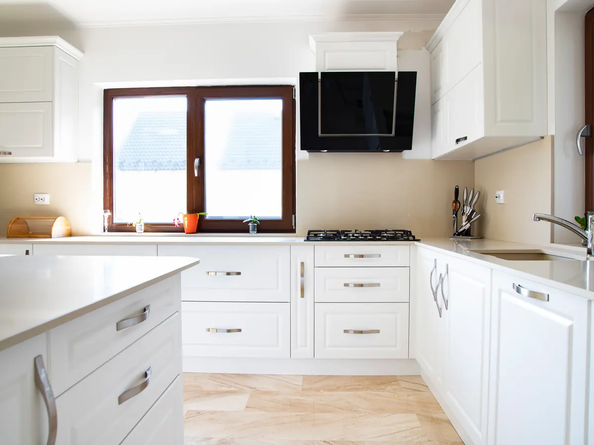 Bright kitchen with white painted shaker cabinets and black hardware