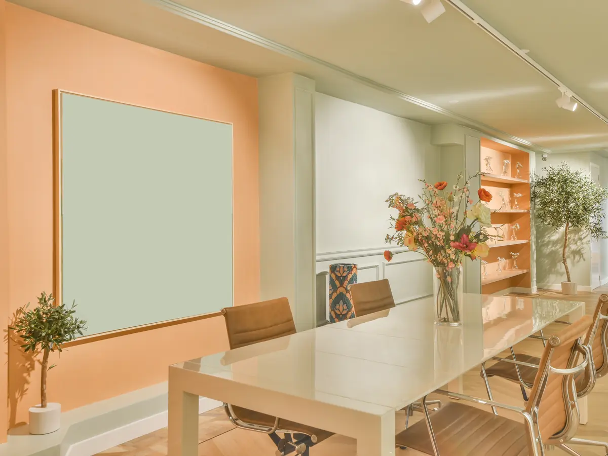 Conference room with peach painted walls and a long meeting table