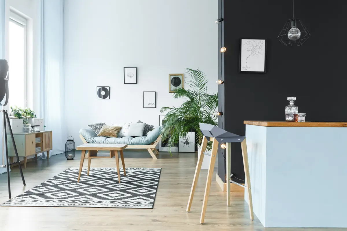 Bright living room with white walls and a charcoal black accent wall, interior painting by Blue Oak Painting Company in Houston, TX